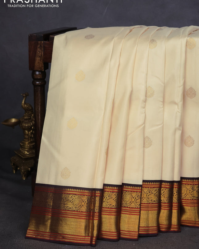 Pure kanchipuram silk saree off white and coffee brown with zari woven buttas and zari woven korvai border