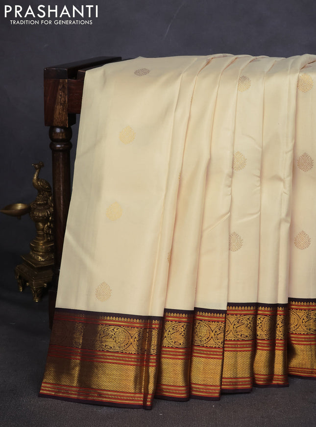 Pure kanchipuram silk saree off white and coffee brown with zari woven buttas and zari woven korvai border