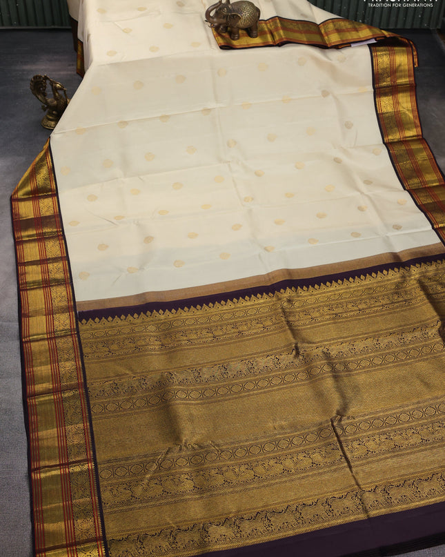 Pure kanchipuram silk saree off white and coffee brown with zari woven buttas and zari woven korvai border