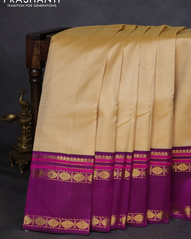 Pure kanchipuram silk saree sandal and purple with plain body and rettapet zari woven border