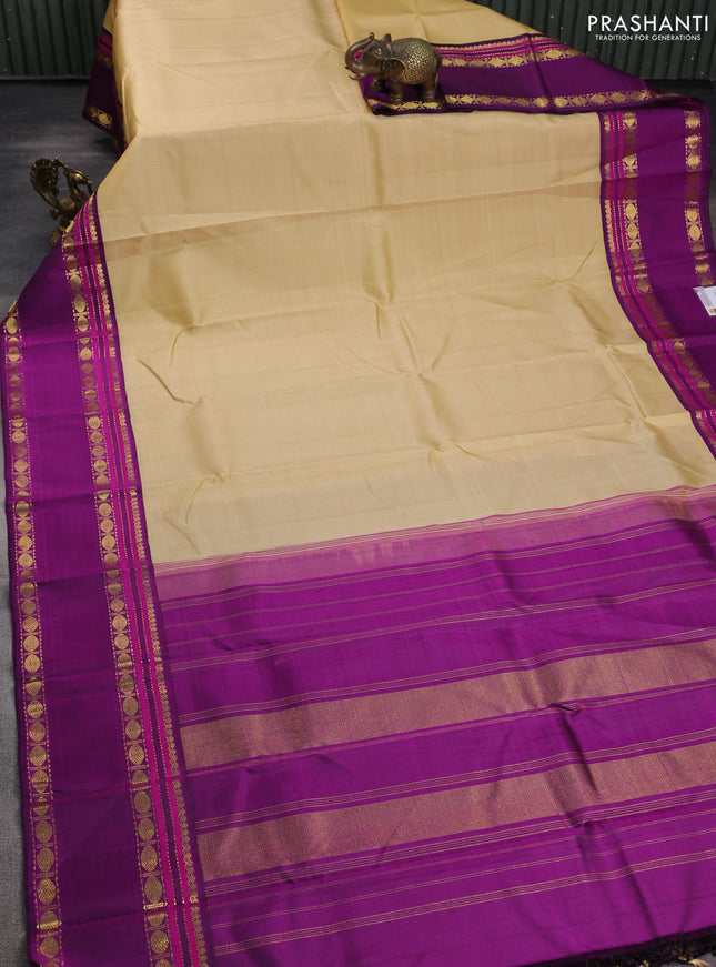 Pure kanchipuram silk saree sandal and purple with plain body and rettapet zari woven border