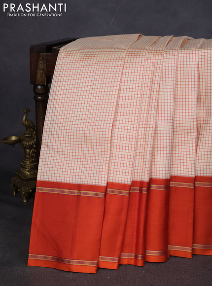 Pure kanchipuram silk saree off white and orange with allover thread woven checked pattern and rettapet zari woven border