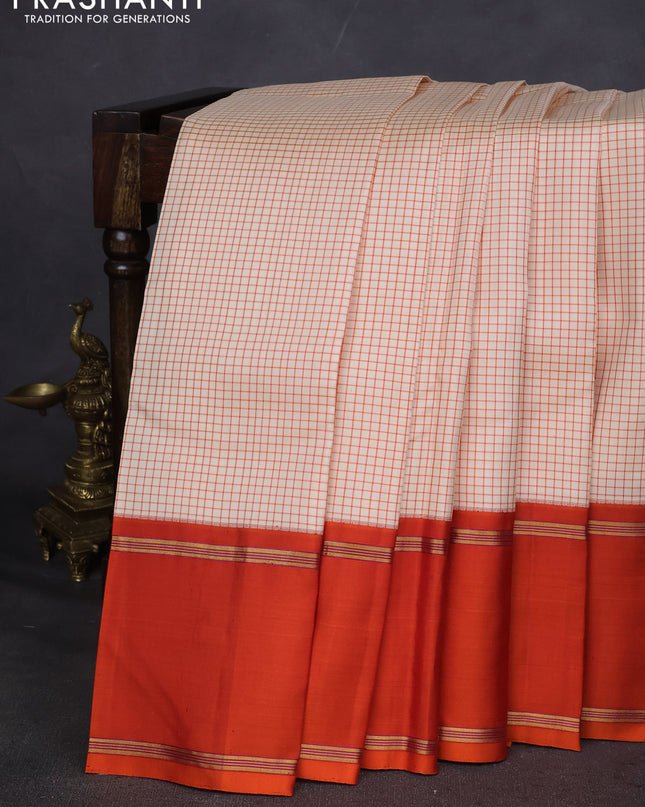 Pure kanchipuram silk saree off white and orange with allover thread woven checked pattern and rettapet zari woven border