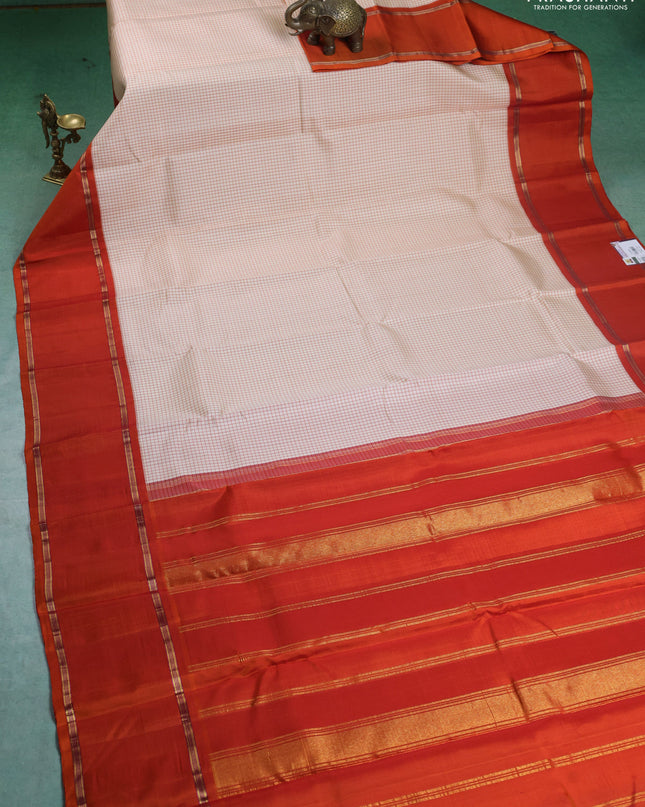 Pure kanchipuram silk saree off white and orange with allover thread woven checked pattern and rettapet zari woven border