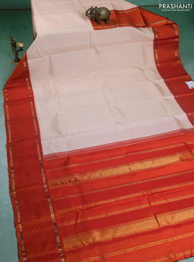 Pure kanchipuram silk saree off white and orange with allover thread woven checked pattern and rettapet zari woven border