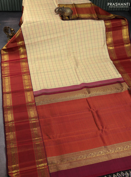 Pure kanchipuram silk saree sandal and deep maroon with allover thread woven checked pattern and long zari woven korvai border