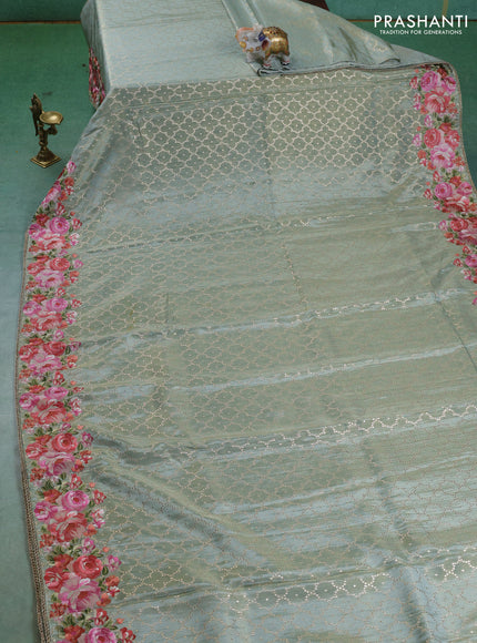 Banarasi silk saree pastel green with allover geometric zari weaves and floral design embroidery border