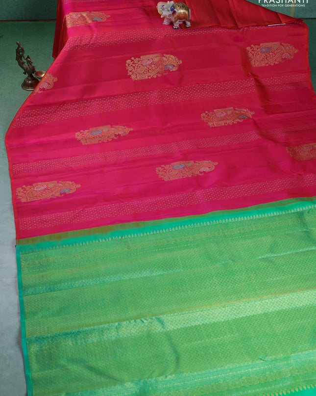 Pure kanchipuram silk saree dual shade of pinkish orange and teal green with zari weaves & buttas in borderless style