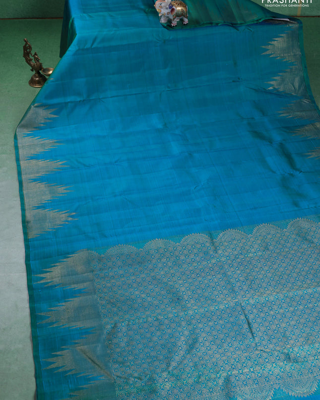 Pure kanchipuram silk saree teal blue with plain body and temple design zari woven border