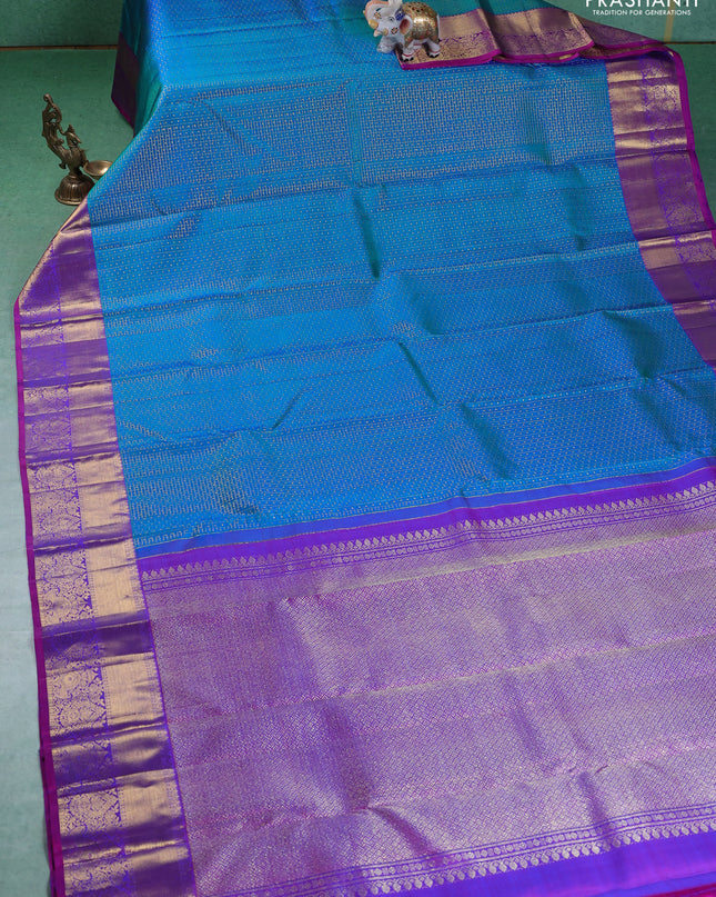 Pure kanchipuram silk saree dual shade of teal blue and orange with allover zari checks & lakshadeepam buttas and zari woven border