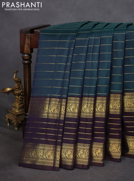 Pure kanchipuram silk saree peacock blue and deep wine with allover zari stripes pattern and long zari woven border