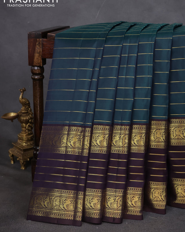 Pure kanchipuram silk saree peacock blue and deep wine with allover zari stripes pattern and long zari woven border
