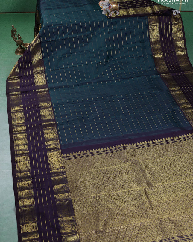 Pure kanchipuram silk saree peacock blue and deep wine with allover zari stripes pattern and long zari woven border