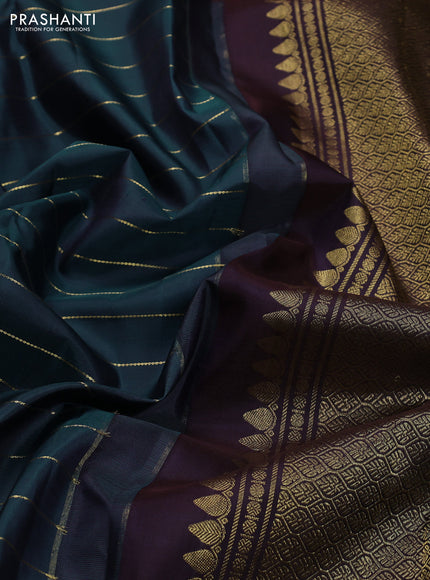 Pure kanchipuram silk saree peacock blue and deep wine with allover zari stripes pattern and long zari woven border