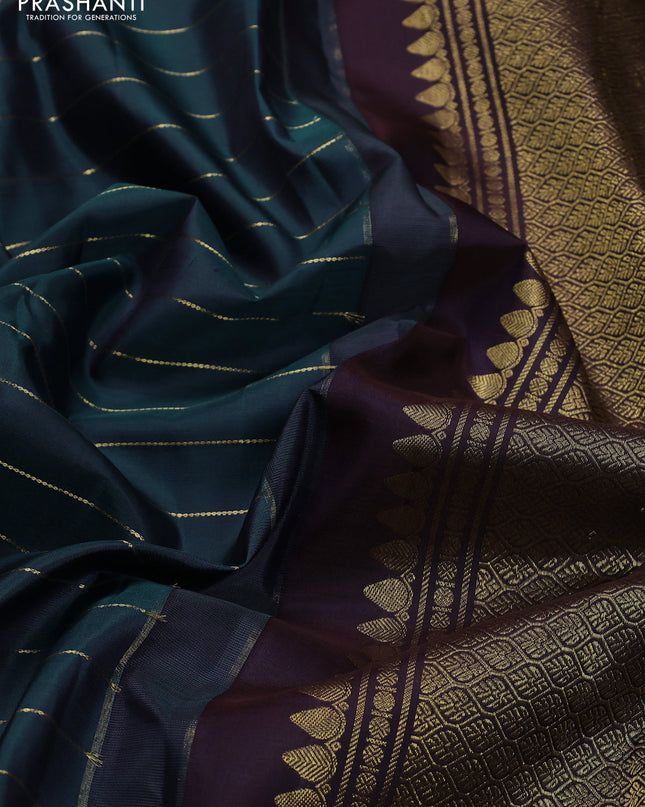 Pure kanchipuram silk saree peacock blue and deep wine with allover zari stripes pattern and long zari woven border