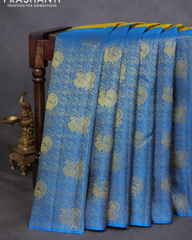 Pure kanchipuram silk saree mehendi green and cs blue with half & half style and long zari woven border