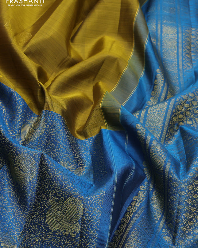 Pure kanchipuram silk saree mehendi green and cs blue with half & half style and long zari woven border