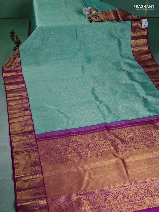 Pure kanchipuram silk saree teal blue and purple with allover zari woven brocade weaves and zari woven korvai border