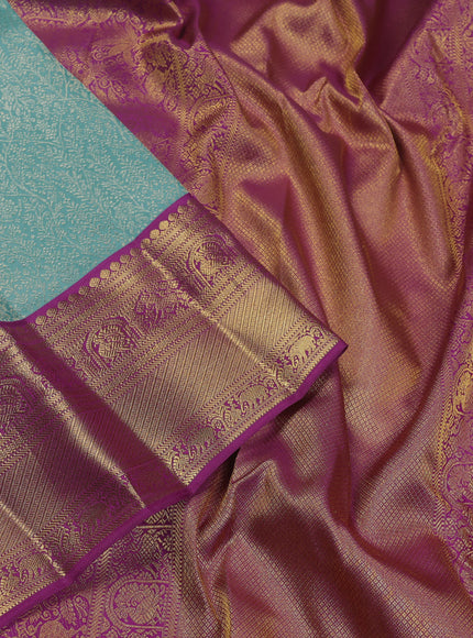 Pure kanchipuram silk saree teal blue and purple with allover zari woven brocade weaves and zari woven korvai border