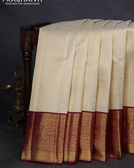 Pure kanchipuram silk saree cream and maroon with allover zari woven brocade weaves and zari woven korvai border