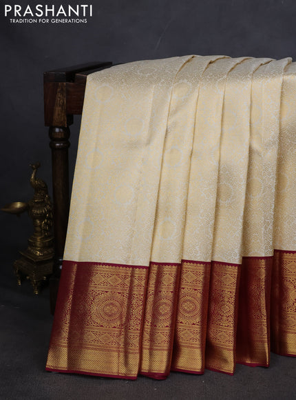 Pure kanchipuram silk saree cream and maroon with allover zari woven brocade weaves and zari woven korvai border