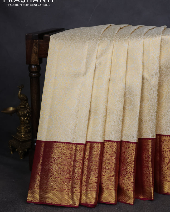 Pure kanchipuram silk saree cream and maroon with allover zari woven brocade weaves and zari woven korvai border