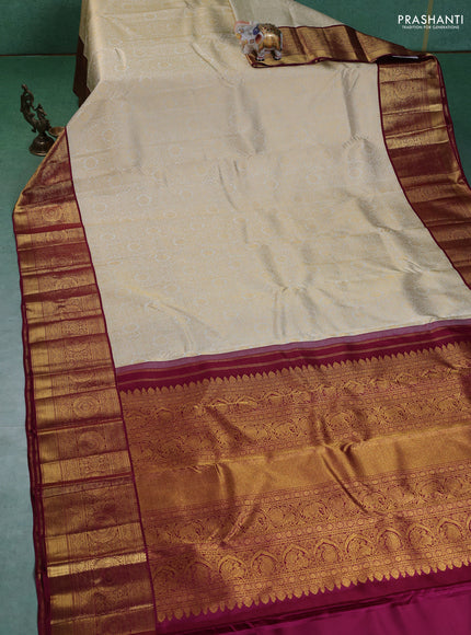 Pure kanchipuram silk saree cream and maroon with allover zari woven brocade weaves and zari woven korvai border
