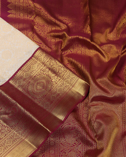 Pure kanchipuram silk saree cream and maroon with allover zari woven brocade weaves and zari woven korvai border