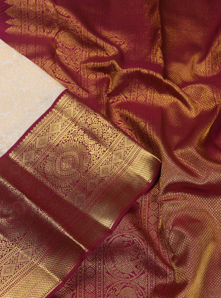 Pure kanchipuram silk saree cream and maroon with allover zari woven brocade weaves and zari woven korvai border