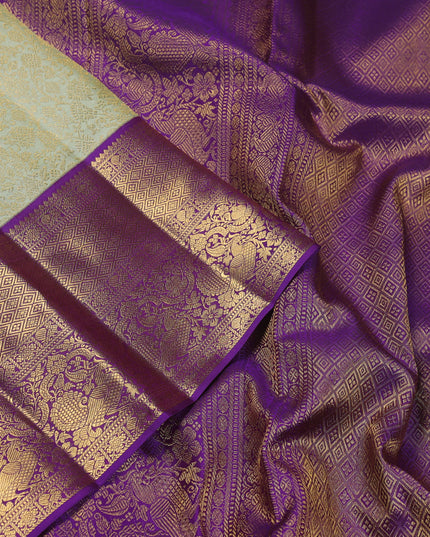 Pure kanchipuram silk saree pista green and violet with allover zari woven brocade weaves and zari woven korvai border