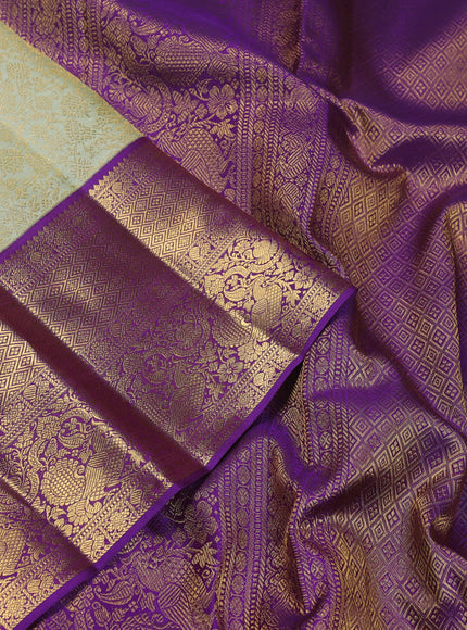 Pure kanchipuram silk saree pista green and violet with allover zari woven brocade weaves and zari woven korvai border
