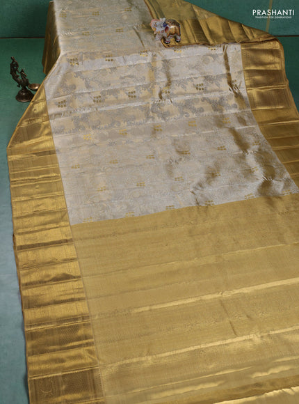 Pure kanchipuram silk saree gold and sandal with allover zari woven brocade weaves and zari woven korvai border