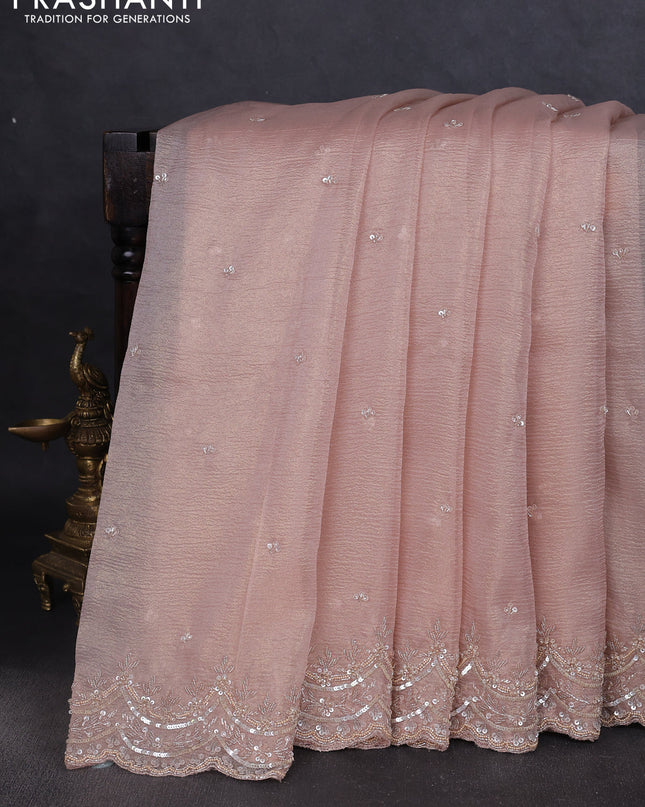 Crush tissue saree mild peach and wiith allover sequin work and embroidery border
