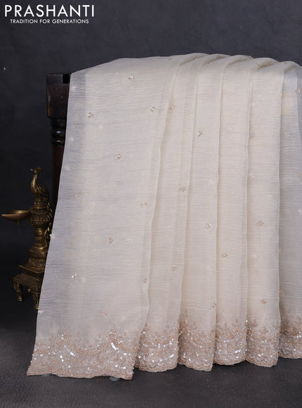 Crush tissue saree off white and wiith allover sequin work and embroidery border