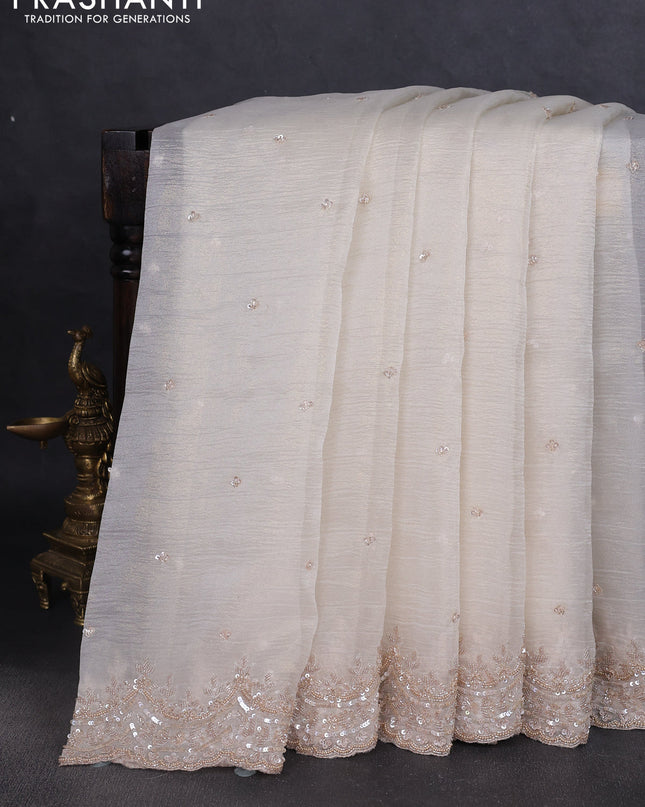 Crush tissue saree off white and wiith allover sequin work and embroidery border