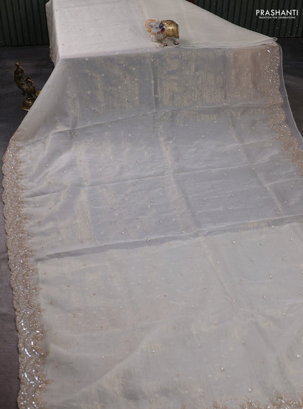 Crush tissue saree off white and wiith allover sequin work and embroidery border