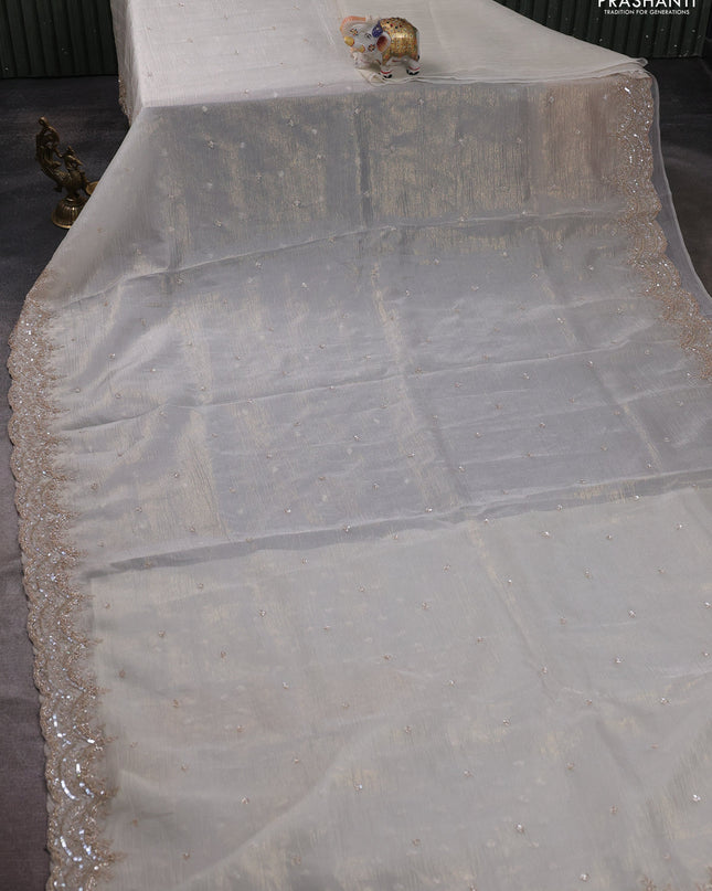 Crush tissue saree off white and wiith allover sequin work and embroidery border