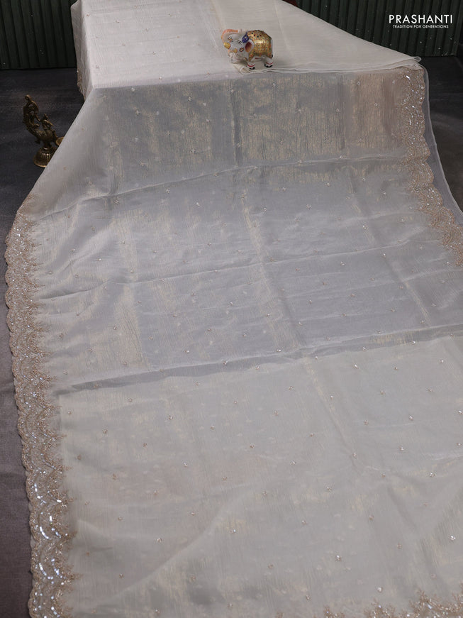 Crush tissue saree off white and wiith allover sequin work and embroidery border