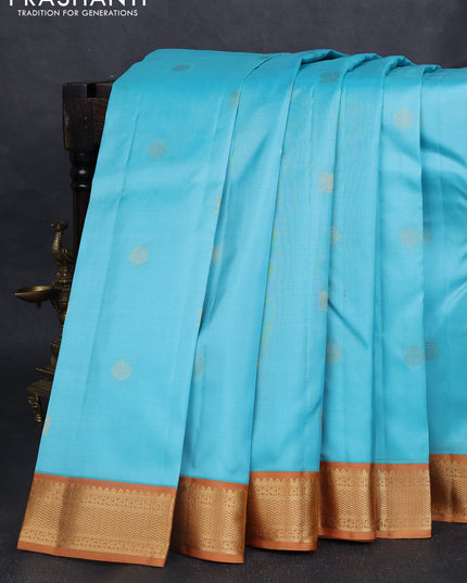 Pure kanchipuram silk saree light blue and dark mustard with annam & rudhraksha zari woven buttas and zari woven korvai border