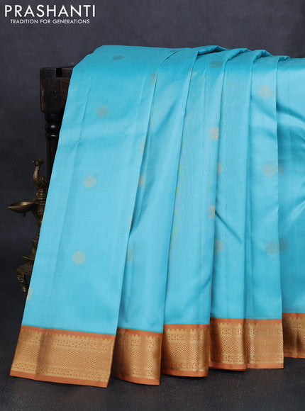 Pure kanchipuram silk saree light blue and dark mustard with annam & rudhraksha zari woven buttas and zari woven korvai border