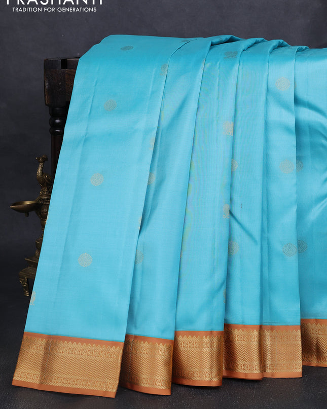 Pure kanchipuram silk saree light blue and dark mustard with annam & rudhraksha zari woven buttas and zari woven korvai border