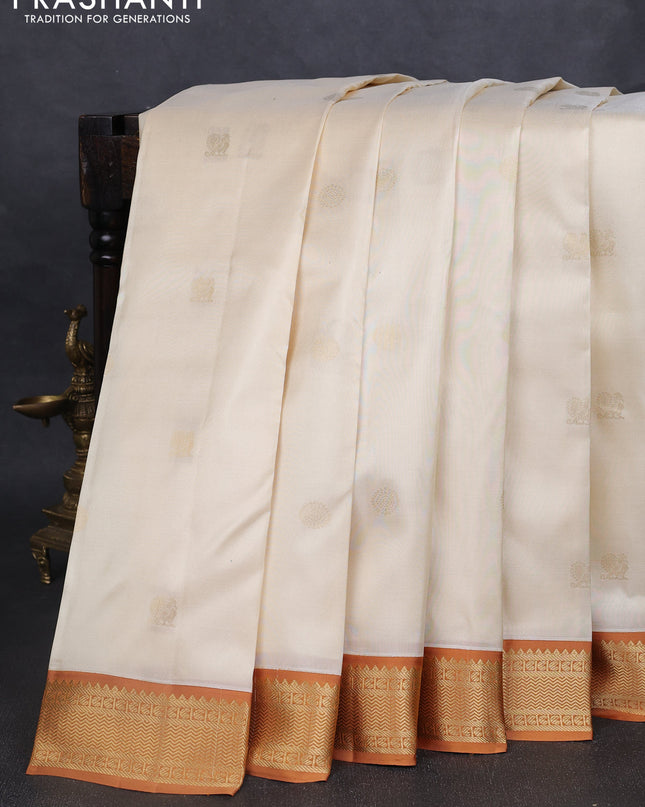 Pure kanchipuram silk saree cream and dark mustard with annam & rudhraksha zari woven buttas and zari woven korvai border