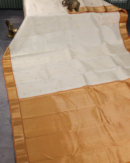 Pure kanchipuram silk saree cream and dark mustard with annam & rudhraksha zari woven buttas and zari woven korvai border