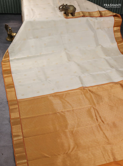 Pure kanchipuram silk saree cream and dark mustard with annam & rudhraksha zari woven buttas and zari woven korvai border