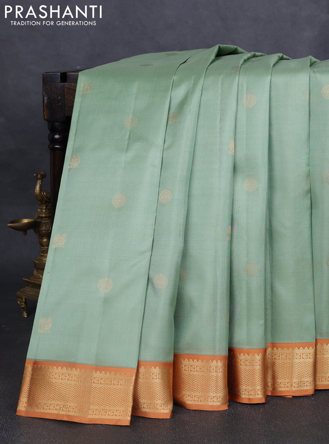 Pure kanchipuram silk saree pastel green and dark mustard with annam & rudhraksha zari woven buttas and zari woven korvai border