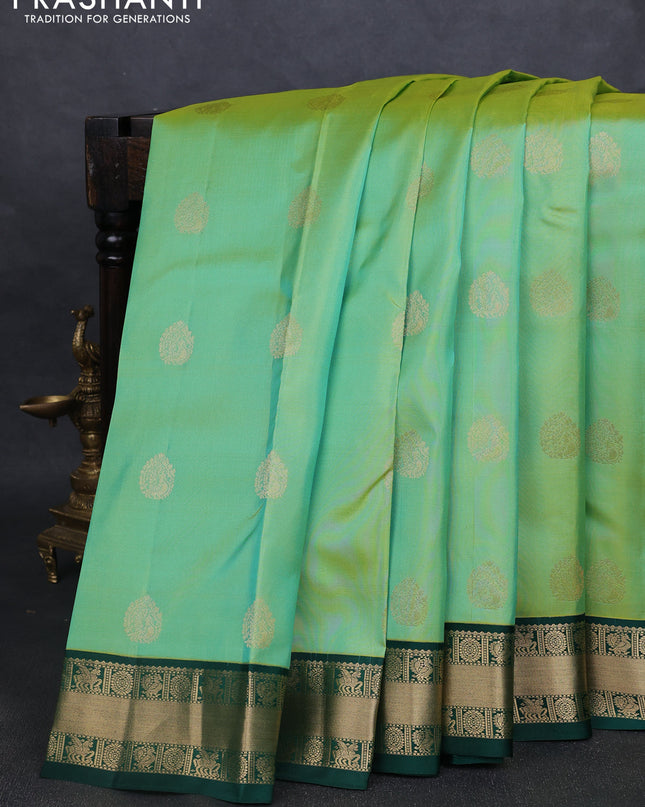 Pure kanchipuram silk saree pista green and green with annam zari woven buttas and zari woven korvai border