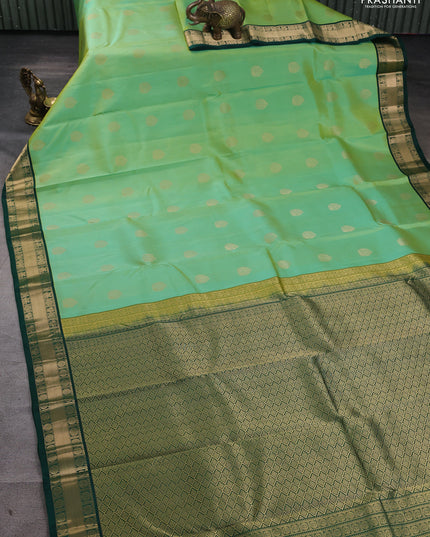 Pure kanchipuram silk saree pista green and green with annam zari woven buttas and zari woven korvai border