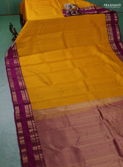 Pure kanchipuram silk saree yellow and dark magenta with allover self emboss pattern and rettapet zari woven border