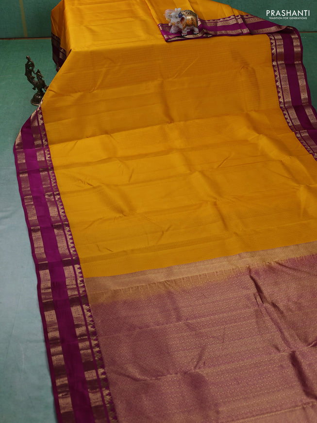 Pure kanchipuram silk saree yellow and dark magenta with allover self emboss pattern and rettapet zari woven border
