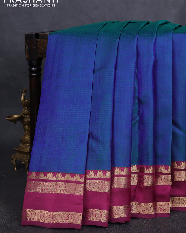 Pure kanchipuram silk saree dual tone bluish green and dark magenta with allover self emboss pattern and rettapet zari woven border